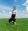 Woman with a briefcase walking on grass