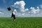 Woman with a briefcase walking on grass