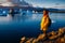 Woman in bright yellow raincoat near the Glacier Lagoon