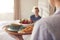 Woman Bringing Man Breakfast In Bed To Celebrate Wedding Anniversary