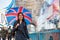 Woman with a British flag umbrella walks on the Tower Bridge