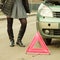 Woman, broken car and auto triangle on road