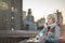 Woman on the Brooklyn Bridge Looking at Manhattan with a Coffee