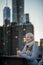 Woman on the Brooklyn Bridge Looking at Manhattan with a Coffee