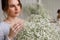 Woman with brown eyes, with bouquet of gypsophila flowers