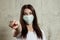 Woman with brown hair and a medical mask for protection again influenza. Shallow depth of field. Copy space for your text