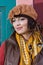 Woman in a brown hat by the colorful wall