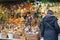 Woman browses a stall of Christmas decorations in Glasgow