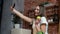 Woman browsing on mobile phone at home kitchen. Young woman browsing on smartphone smiling happy. A woman eats an apple