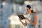 Woman browsing tablet videos in a town at sunset