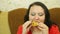 Woman brunette eats fried chicken face large.