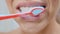 Woman brushes teeth with toothbrush