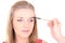 Woman brushing eyebrows with makeup brush