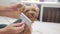 Woman brushing her dog. dog lifestyle funny video. girl combing a little shaggy dog pet care. woman using a comb brush