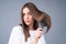 Woman brushing straight natural hair with comb. Girl combing hair with hairbrush. Hair care beauty concept. Brushing