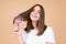 Woman brushing straight natural hair with comb. Girl combing healthy hair with hairbrush. Hair care beauty concept