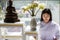 Woman Buddhist in white dress sitting and doing meditation in front of set of altar table with buddha image. Idea for ritual and