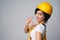 Woman builder wearing yellow protect helmet and overall showing OK