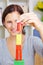 Woman building tower with building blocks