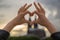 Woman builds love sign in front of the cologne cathedral