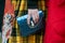 Woman with Bulgari blue bag and yellow tartan skirt before Emporio Armani fashion show, Milan Fashion Week