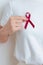 woman with Burgundy Red Ribbon for March multiple myeloma Cancer and December World Aids Day Awareness month. Healthcare and world