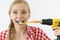 Woman burshing her teeth using drill