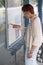 Woman at bus stop looking at timetable