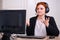 A woman in a business suit doesn`t know what to do and throws up her hands. Problems of working remotely from home during