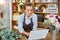 Woman busy working on laptop at flower shop