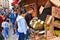 woman buy durian fruit at a stand on little china streets in Manhattan with background of crowd of people, New York