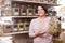 Woman buyer selects herbs in store of ecological products