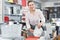 Woman buyer trying kitchen rack in the tableware shop