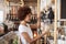 Woman Buying Cereals And Grains In Sustainable Plastic Free Grocery Store