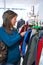 Woman Buying Children\'s Clothes In Charity Shop