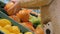 Woman buying fresh exotic citrus fruits at grocery store