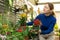 Woman buying kalanchoe blossomfeld in flower shop