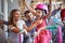 Woman buying new bicycle and helmet for little girl in bike shop