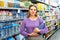 Woman buying still water in supermarket