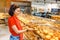 Woman buys bakery at bread store