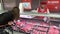 Woman buys meat and other food products in supermarket.