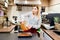 Woman cafe worker prepares sweet dessert cake