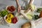 Woman came back from a market and unpacks a reusable grocery bag full of vegetables on a kitchen at home. Zero waste and