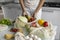 Woman came back from a market and unpacks a reusable grocery bag full of vegetables on a kitchen at home. Zero waste and