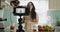 Woman, camera and live streaming in kitchen, blog and tutorial or teaching at home on broadcast. Female influencer
