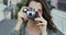 Woman, camera and photography in city with face, smile and travel blogger or influencer outdoor. Female photographer on