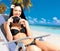 Woman with a camera taking photos on beach