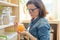 Woman with can of fresh natural organic golden honey