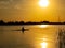 Woman canoeing at sunset on Vistula river, Poland.