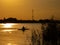 Woman canoeing at sunset on Vistula river, Poland. Amazing scenery and colors.